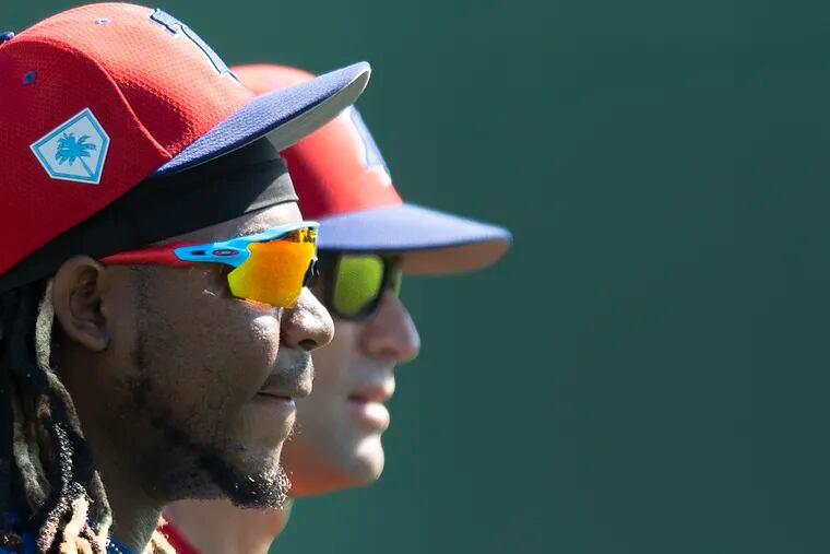 Phillies third baseman Maikel Franco, left, and manager, Gabe Kapler, watching spring training workouts. Franco will bat eighth in the Phillies' opener against the Braves.