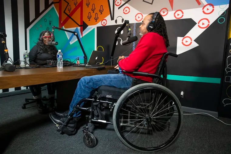 Victoria Wylie, left, interviews Charles "Chuck" Horton, who was shot and paralyzed as a teenager during a podcast recording session in January. Members of a support group for paralyzed gunshot victims have started a podcast in an effort to share their stories more widely and bring support to others in and around Philadelphia.