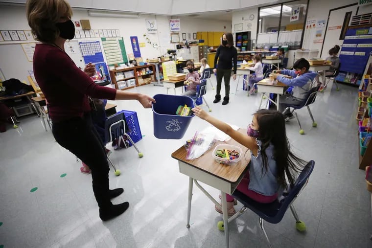 Kindergarten teacher Jennifer Klein collects crayons from students in the classroom at Lupine Hill Elementary School in Calabasas as one of the first elementary schools to open up in L.A. County on Nov. 9, 2020. (Al Seib/Los Angeles Times/TNS)