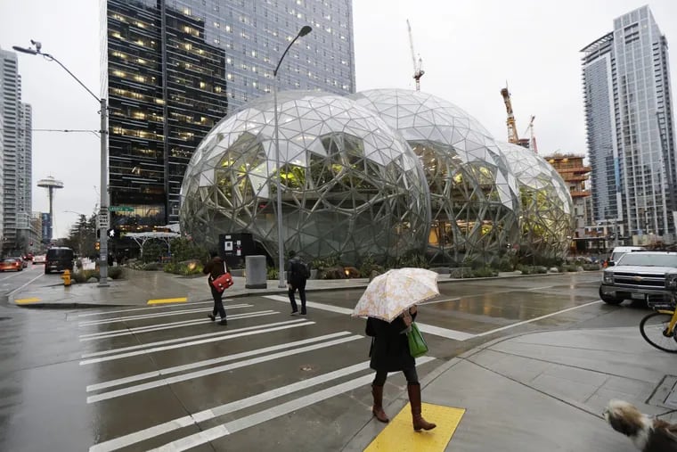 Pedestrians walk past the Amazon Spheres at the company’s headquarters in downtown Seattle.