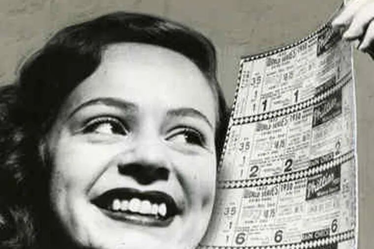 Mary Alice Sullivan, of the Phillies office staff, displays 1950 World Series tickets.