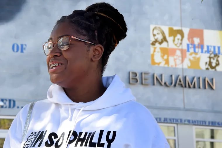 Mecca Taylor, a senior at Benjamin Franklin High, is shown outside her school building, which is closed until construction and asbestos abatement is completed.