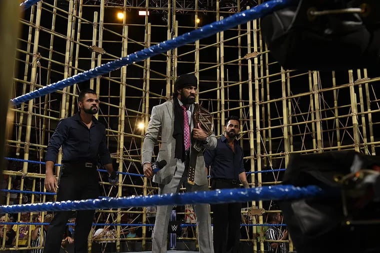WWE champion Jinder Mahal (center) stands alongside the Singh Brothers inside the Punjabi Prison, where he face Randy Orton at Battleground Sunday.