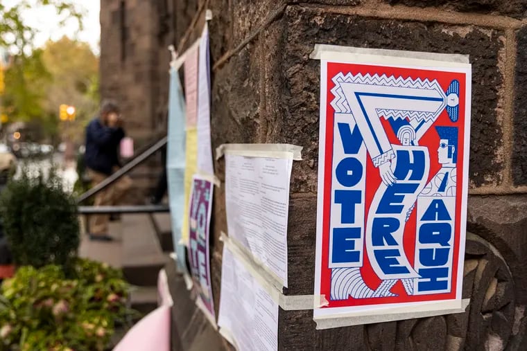 Signs posted outside a polling place at Trinity Memorial Church in Fitler Square in November 2021.