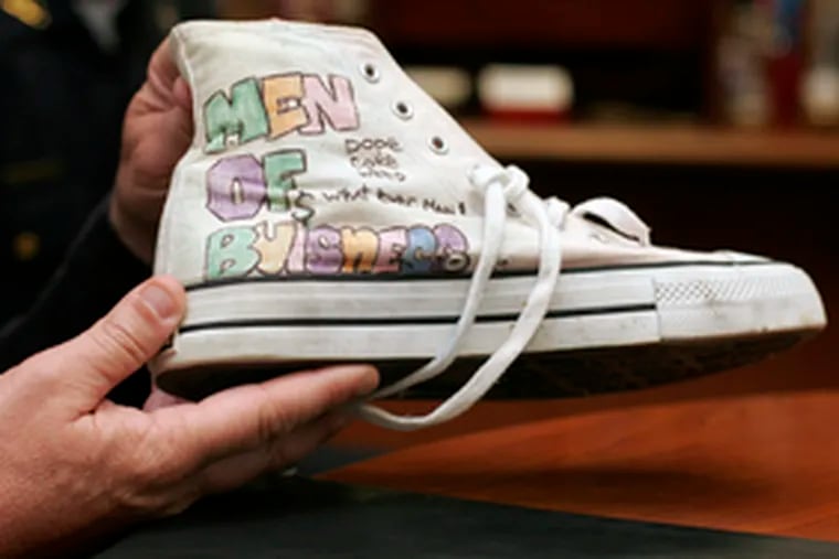 The words on this sneaker taken from an inmate at the Camden jail start with &quot;MOB&quot; - meaning &quot;Member of Bloods.&quot;