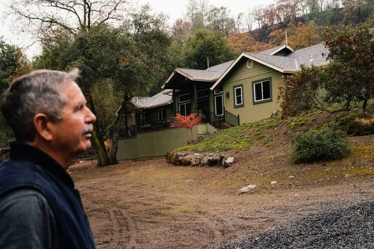 Jeff Moore surveys his home in Chico, California, this week. He and his wife have worked to keep the area around their home clear of brush, which helped keep the wildfire away.