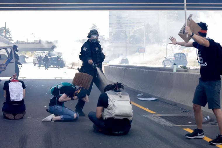 Philadelphia SWAT officer Richard P. Nicoletti shown pepper spraying three kneeling protesters on I-676 on June 1. Nicoletti was charged with simple assault, reckless endangerment, official oppression, and possession of an instrument of crime.