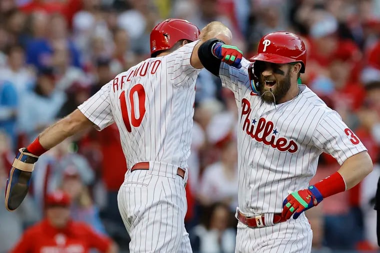 Bryce Harper celebrates his two-run homer with J.T. Realmuto. Harper's shot came moments after a three-run blast from Rhys Hoskins.