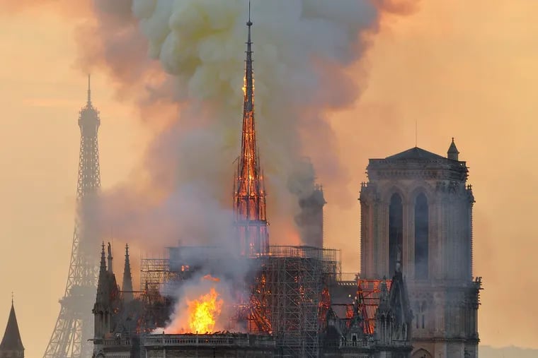 Flames and smoke rise from the blaze at Notre Dame Cathedral in Paris that destroyed its spire and its roof but spared its twin medieval bell towers. Some bristle at rebuilding efforts in the wake of poverty.