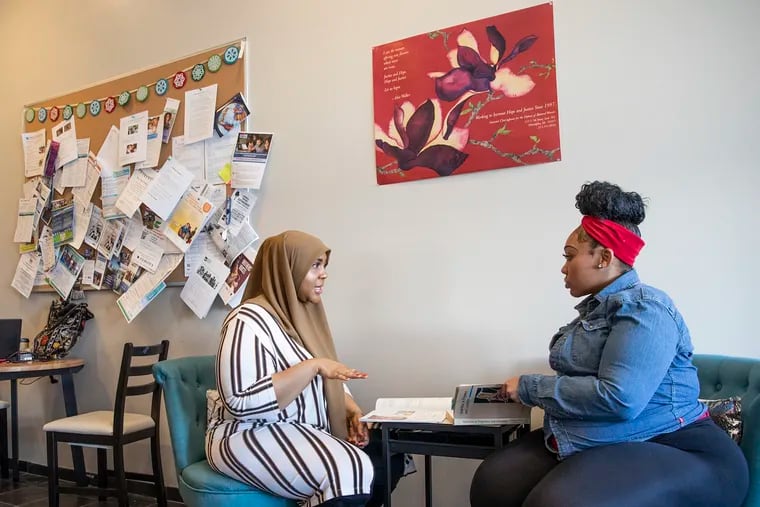 Ayesha Uqdah (left) a community health worker with Maternity Care Coalition, meets with her client, Chaffon Williams at the Maternity Care Coalition Office in Mantua last year.