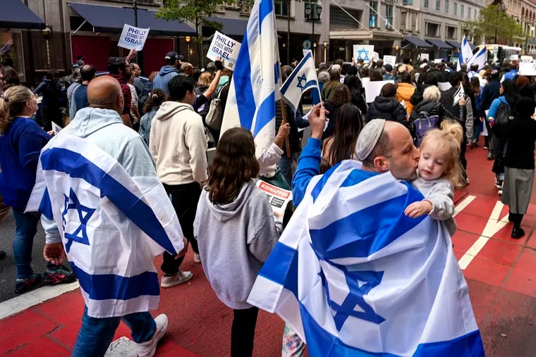 Benaya Yehuda kisses 21 month-old Yarid as they march from City Hall to Independence Hall with the Jewish Federation of Greater Philadelphia in October.