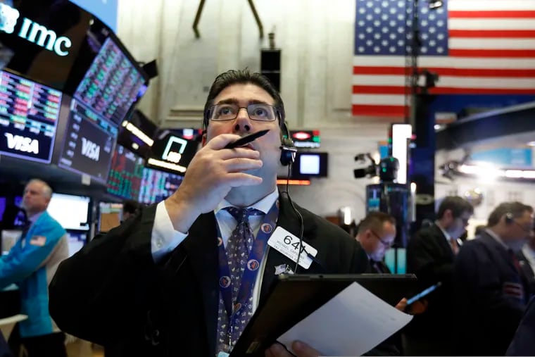 Trader Michael Capolino works on the floor of the New York Stock Exchange. Stock markets continued to fall even after the surprise fed rate cut, which mutual funds giant Vanguard called a high risk bet.