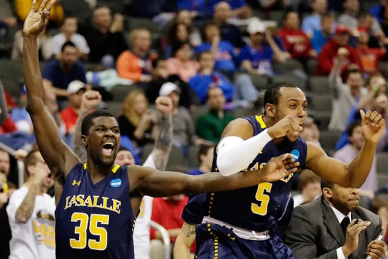 La Salle's Rohan Brown (35) and Taylor Dunn (5) celebrate after
defeating Mississippi 76-74 in a third-round game of the NCAA college
basketball tournament, Sunday, March 24, 2013, in Kansas City, Mo. (Charlie Riedel/AP)