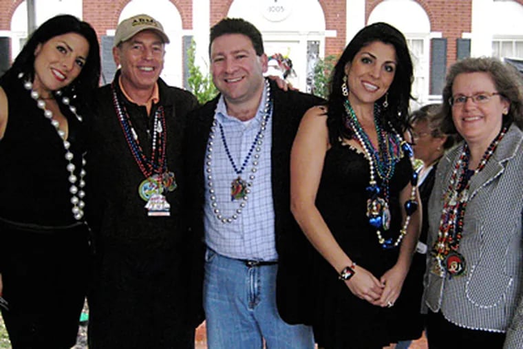 A complaint by Jill Kelley (second from right), an unpaid social "ambassador" to the MacDill Air Force Base in Tampa, led to the FBI investigation that felled Gen. David Petraeus (second from left). Also pictured at a Tampa parade in 2010 are Kelley's twin, Natalie Khawam; husband, Scott Kelley and the general's wife, Holly Petraeus. (Associated Press)