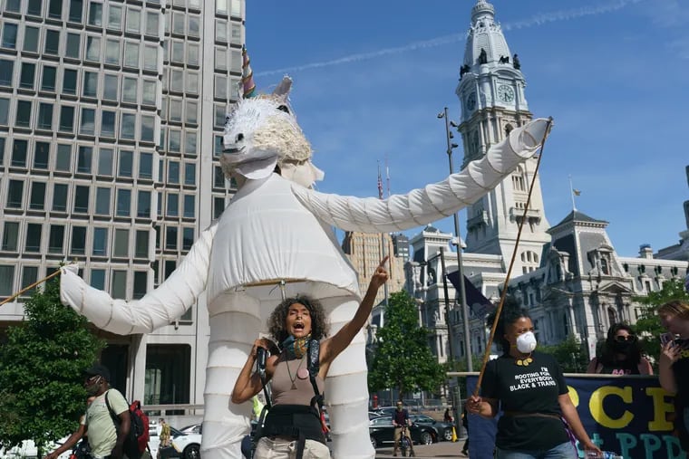 Samantha Rise, Program director at Girls Rock Philly, left, shown here with a unicorn puppet at a protest and arts event organized by the Artist Coalition for a Just Philadelphia, who held an Emergency Art Action to Fund Black Futures on June 16th, 2020.