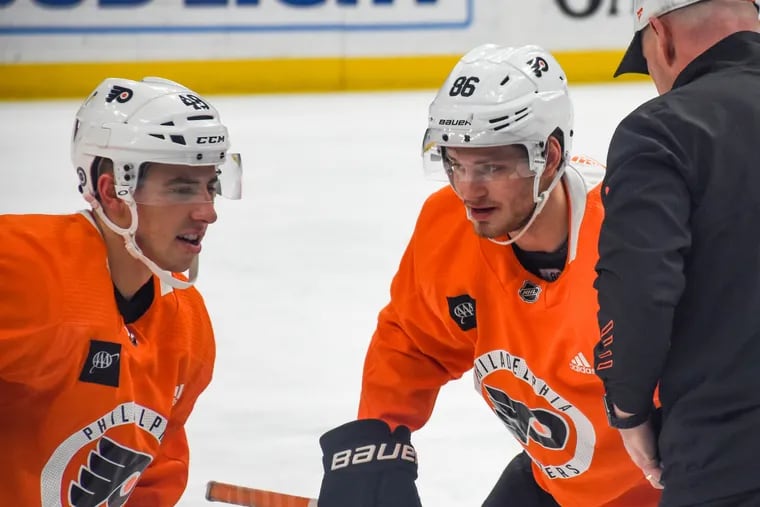 Morgan Frost, right, and Joel Farabee practice faceoffs at the Philadelphia Flyers morning skate ahead of their game against the St. Louis Blues on Thursday, Mar. 24, 2022. Farabee, typically a left wing, played center in the Flyers' Tuesday game against the Detroit Red Wings.