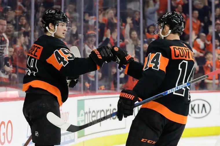 Flyers left winger Joel Farabee (left) celebrates his goal with teammate Sean Couturier against the Colorado Avalanche earlier this month.