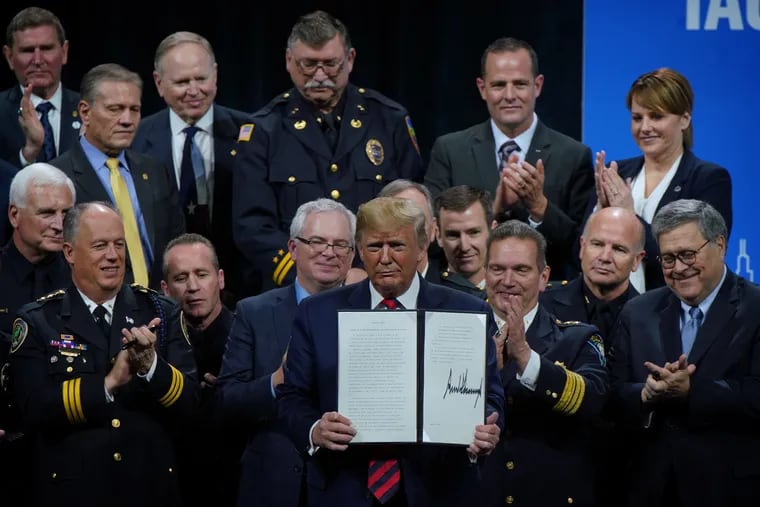 President Donald J. Trump signs an executive order establishing a new executive "Commission on Law Enforcement" and the "Administration of Justice" at the International Association of Chiefs of Police Annual Conference at McCormick Place Monday, October 28, 2019. (E. Jason Wambsgans/Chicago Tribune/TNS)