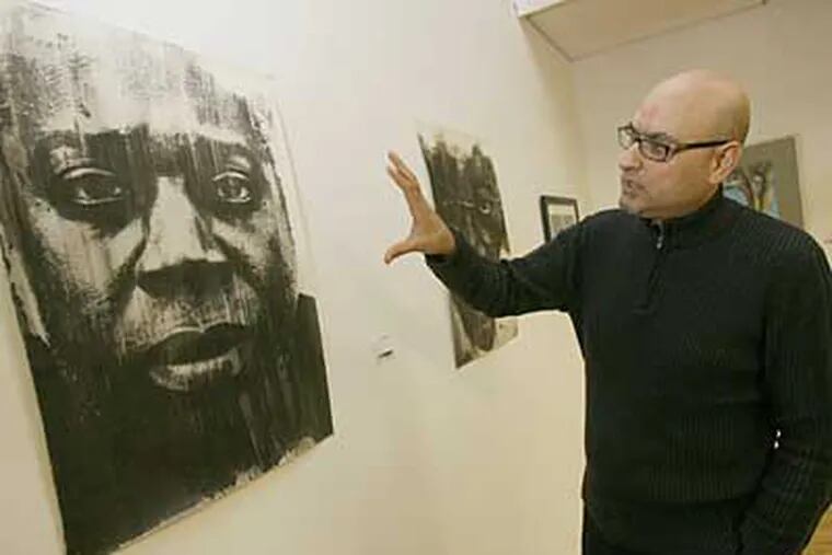 Antonio Puri, organizer of the Art4Barter show, in its current venue in Haddon Heights. The West Chester-based artist says the barter system helps to connect artists with art lovers. (Charles Fox / Staff Photographer)