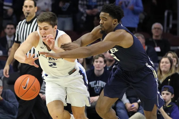 Collin Gillespie, left, of Villanova and Quentin Goodin, right, of Xavier go after a loose ball during the 2nd half at the Wells Fargo Arena on Jan. 18, 2019.