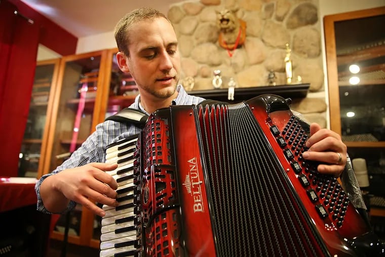 Mike Bulboff, owner of Liberty Bellows in Queen Village, plays an accordion in his Philadelphia shop.