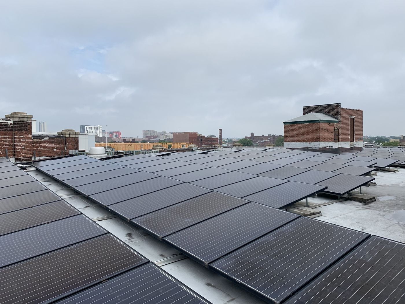 The roof of the Crane Arts Building, in North Philadelphia, is covered in 82 kilowatts of solar panels. People from the clean energy industry gathered beside the panels to discuss the recent report detailing Pennsylvania's clean energy job growth, on Tuesday, June 18.