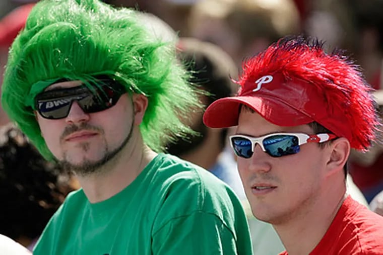 Many Phillies fans show up to games wearing a wide range of team-branded apparel. (Yong Kim/Staff Photographer)
