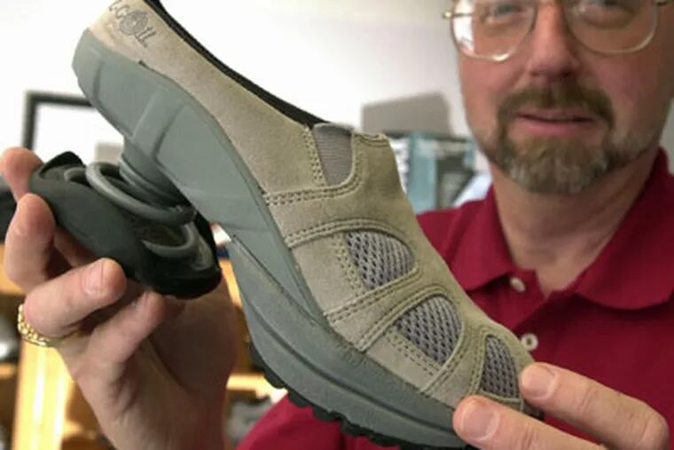 John Mishasek sells Z-Coil shoes at his store in Colorado Springs, Colo. The shoe has a big spring in the heel. (Carol Lawrence / Colorado Springs Gazette)