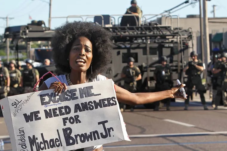 A protester makes her voice heard as a march organized by area ministers makes its way through Ferguson, Mo., on Wednesday, Aug. 13, 2014. (J.B. Forbes/St. Louis Post-Dispatch/MCT)