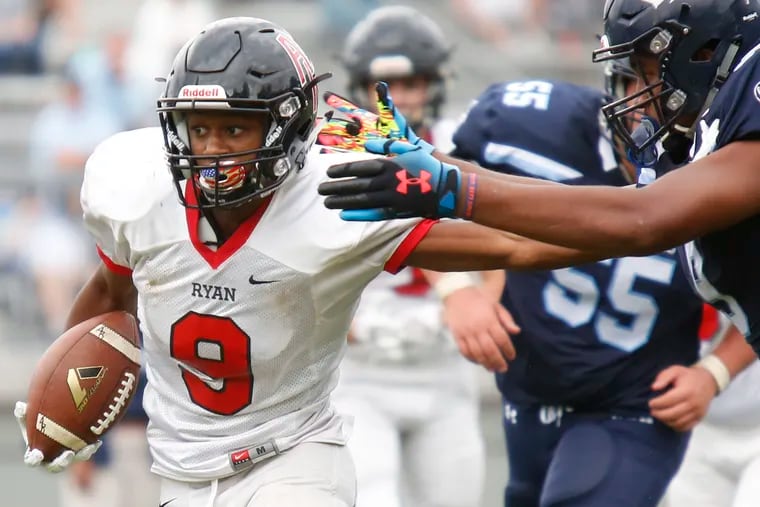 Wide receiver Tyreek Chappelle fends off Springside Chestnut Hill defensive end Brian Richardson when he played for Archbishop Ryan in 2018.