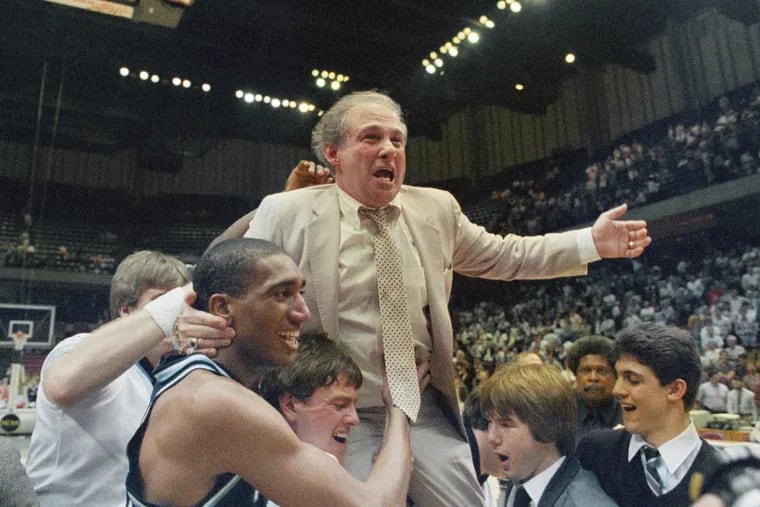 Villanova coach Rollie Massimino takes a victory ride on his players shoulders.