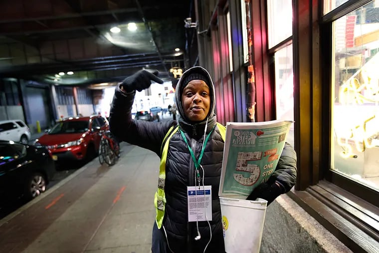 A vendor known as September sells the One Step Away newspaper on Filbert Street next to Reading Terminal Market in Center City. MICHAEL S. WIRTZ / Staff Photographer