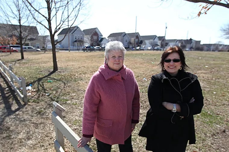 Nilda Ruiz, right, president of Asociacion de Puertorriquenos en March, right, and Rose Gray,left, a senior Vice President, stand in a lot at 8th and Berks streets thay wish to develop into senior housing. They have built 150 homes for ownership in the area. ( MICHAEL BRYANT / Staff Photographer )