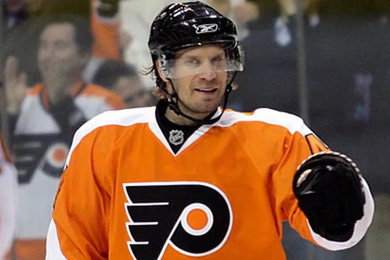 Kimmo Timonen celebrates after scoring a power play goal during the first period. (Yong Kim/Staff Photographer)