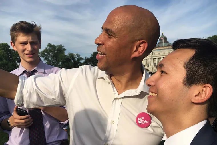 Sen. Cory Booker (D., N.J.) takes a selfie with a supporter on June 28, 2017 after a rally on Capitol Hill against a Republican health bill.