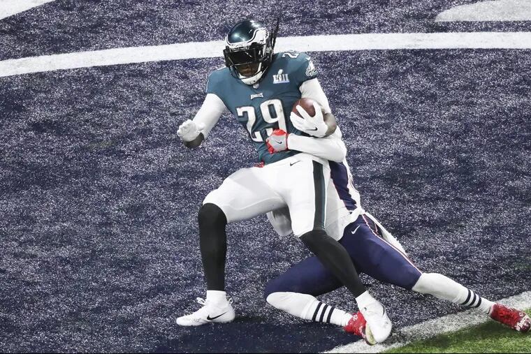 Eagles running back LeGarrette Blount scores over New England Patriots strong safety Duron Harmon during the second quarter at Super Bowl LII.