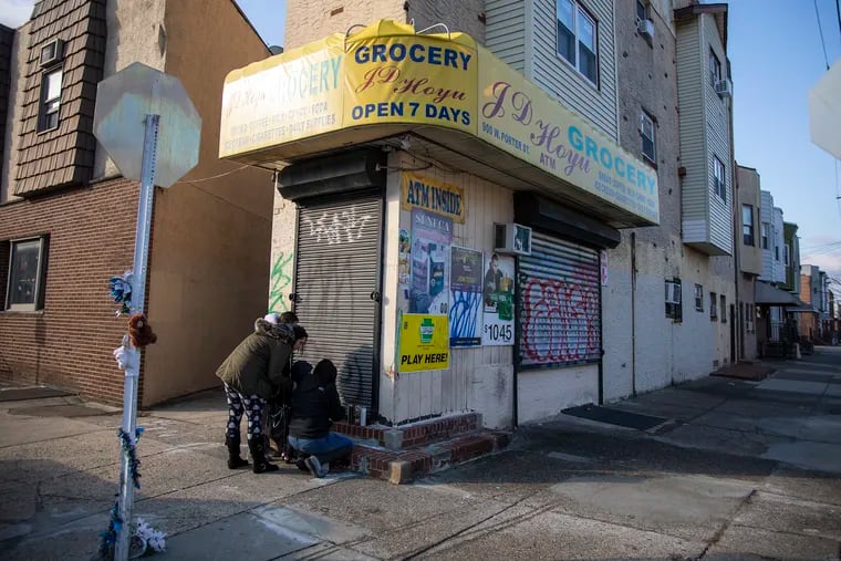 Debbie Leonardi, 53, Ashley Leonardi, 34, niece, Melissa Capozzoli, 28, daughter to Debbie, and Capozzoli's son, Alejandro Torres, 3, came to visit and pay their respects to the family by leaving candles at the J.D. Hoyu Grocery in South Philadelphia at the corner of 9th Street and Porter Street on Wednesday, Jan. 8, 2020. The family are neighborhood friends and live right down the road from the corner store. "They're a nice quiet family," Debbie said. "As soon as I heard I got upset. I hope they catch him."