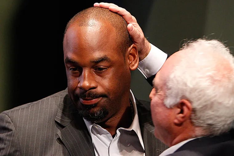 Eagles owner Jeffrey Lurie pats Donovan McNabb as he officially retires as an Eagle.