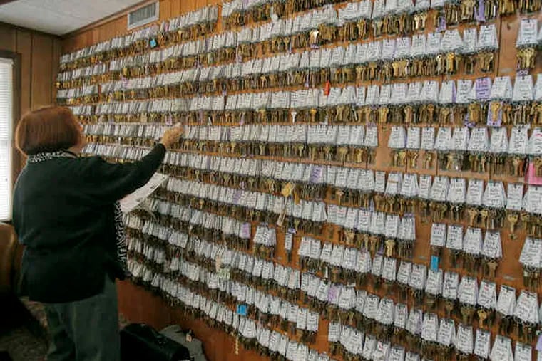 Rental agent Pat Moss picks up keys from a wall full of keys for houses to show to her clients at Berger Realty in Ocean City, N.J. Agencies say rentals are ahead of last year's at this time.