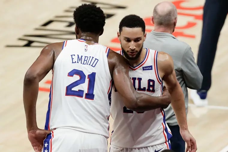 The Philadelphia 76ers' Joel Embiid (21) and Ben Simmons embrace late in the fourth quarter against the Atlanta Hawks in Game 3 of the NBA Eastern Conference semifinals at State Farm Arena in Atlanta. (Yong Kim/The Philadelphia Inquirer/TNS)