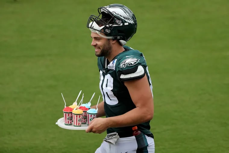 Rookie Dallas Goedert carries a tray of water ice to his fellow tight ends during practice on Tuesday.
