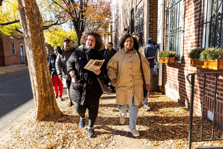 Michiko Quinones, the cofounder of 1838 Black Metropolis and director of Public History and Education, of South, N.J., and Morgan Lloyd, co-founder and president of 1838 Black Metropolis, of West Philadelphia, Pa., lead a group for a walking tour to visit sites of Black history in Philadelphia, Pa., on Saturday, Nov 25, 2023.