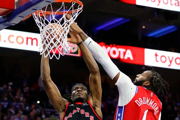 Sixers center Andre Drummond goes up to block Toronto Raptors forward Precious Achiuwa's lay-up attempt during the fourth quarter on Thursday, November 11, 2021 in Philadelphia.  Drummond was initially called for a foul and after official review the foul was changed to a jump ball.