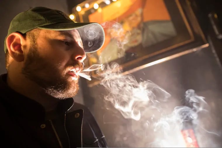 In this Friday, March 29, 2019 photo, a man smokes marijuana at a Spleef NYC canna-cocktail party in New York. As more states make it legal to smoke marijuana, some government officials, researchers and others worry what that might mean for one of the country's biggest public health successes: curbing cigarette smoking. (AP Photo/Mary Altaffer)