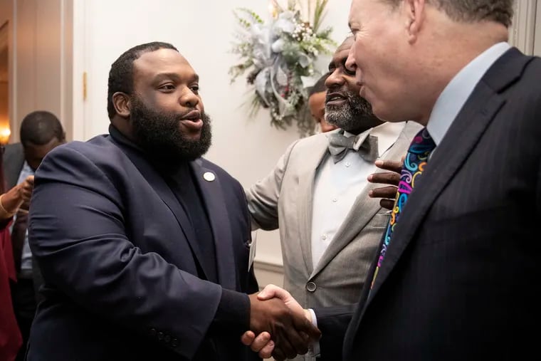 Rep. Jordan Harris (left) shakes the hand of Pittsburgh controller Michael Lamb at an event for the Pennsylvania Society on Dec. 6, 2019.