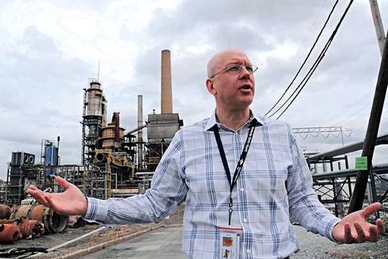 Jonathan Hunt, director of operations of Sunoco's Marcus Hook Industrial Complex, talks April 14, 2014 about his company's plan to demolish Sunoco old petroleum refinery's into one that handles Marcellus Shale natural gas liquids.  Sunoco Logistics is building new above-ground storage equipment for the Marcellus Shale propane and ethane.  In the background is the old Fluid Catalytic Cracking Unit, which is being demolished.  ( CLEM MURRAY / Staff Photographer )