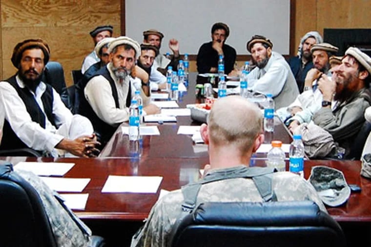 Village elders and troops from the U.S. Provincial Reconstruction Team meet for a "shura," or consultative council, at Forward Operating Base Kala Gush in Nuristan.
