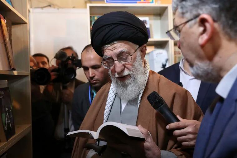 In this picture released on April 29, 2019, by the official website of the office of the Iranian supreme leader, Supreme Leader Ayatollah Ali Khamenei reads part of a book while visiting Tehran's book fair in Tehran, Iran. President Donald Trump signed an executive order on Monday, June 24, 2019, targeting Iran's supreme leader and his associates with financial sanctions, the latest action the U.S. has taken to discourage Tehran from developing nuclear weapons and supporting militant groups. (Office of the Iranian Supreme Leader via AP)