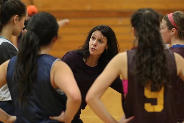 Gloucester Catholic girls basketball Lisa Gedaka, center, explains a defensive move to her varsity team during practice. ( Michael Bryant / Staff Photographer )