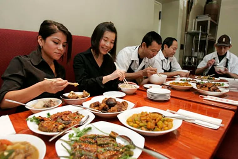 At Hunan in Ardmore, members of the staff - Zulmary Torres, Min Wu, Jiu Lou, Lak Ley, and Savy Kohna - eat together three times a day. Staff meals at other local eateries vary: New menu items may be tested, young chefs may show off their skills, dining-room leftovers may be dressed up and served anew. (DAVID SWANSON / Staff Photographer)